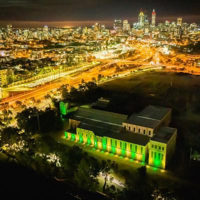 Power Station And Cbd At Night Green And Gold Lighting