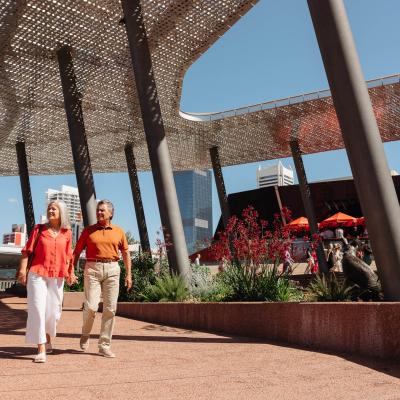 Mature couple walking through Yagan Square Amphitheatre and wildflower garden 